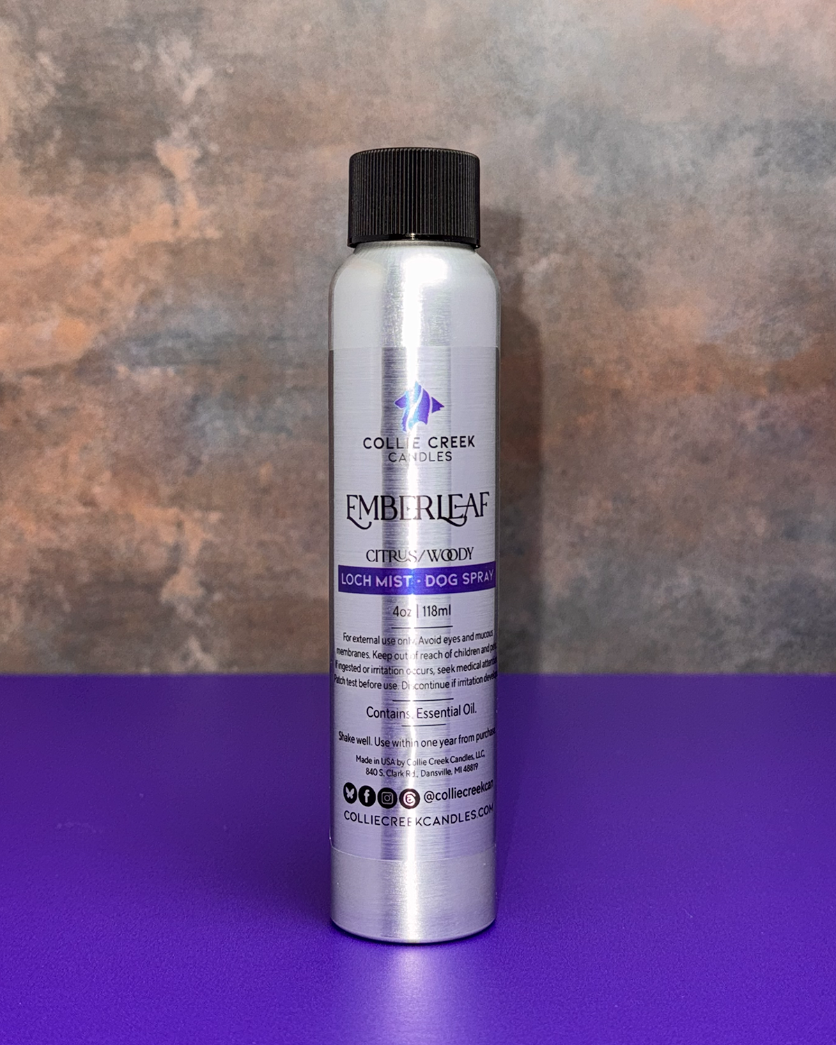Emberleaf Dog Spray. A sliver 4 ounce bottle with a black shipping top. A silver label with black and purple writing.