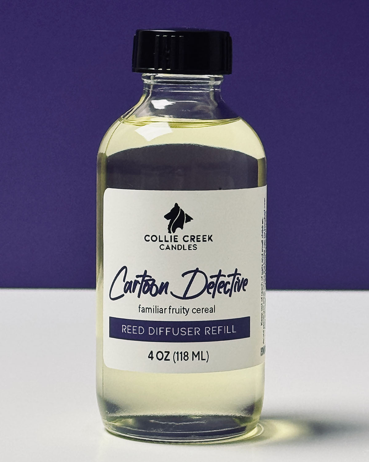 Cartoon Detective reed diffuser refill. Clear liquid in a clear glass bottle on a white and purple background.