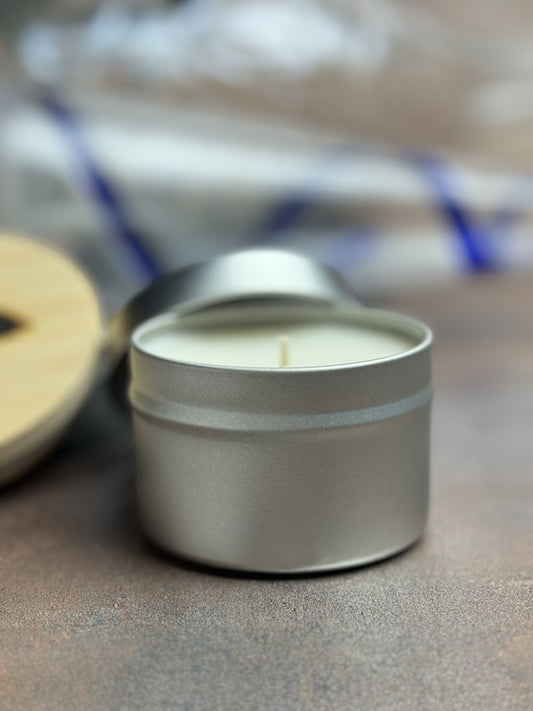 Tin New Year Pawty candle closeup with fallen champagne flute in the background.