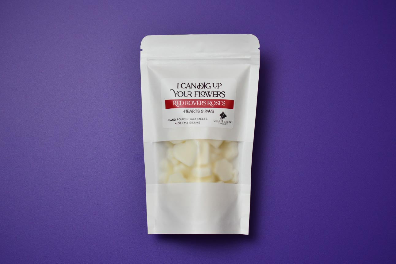 4oz Pouch of Red Rovers Roses wax melts in paw and heart shapes. A white bag on a purple background.