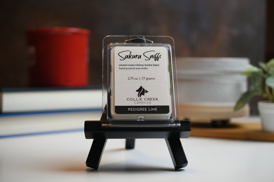 Sakura Sniffs wax melt a 2.75 oz (77 gram) product in a clear plastic clam shell container.