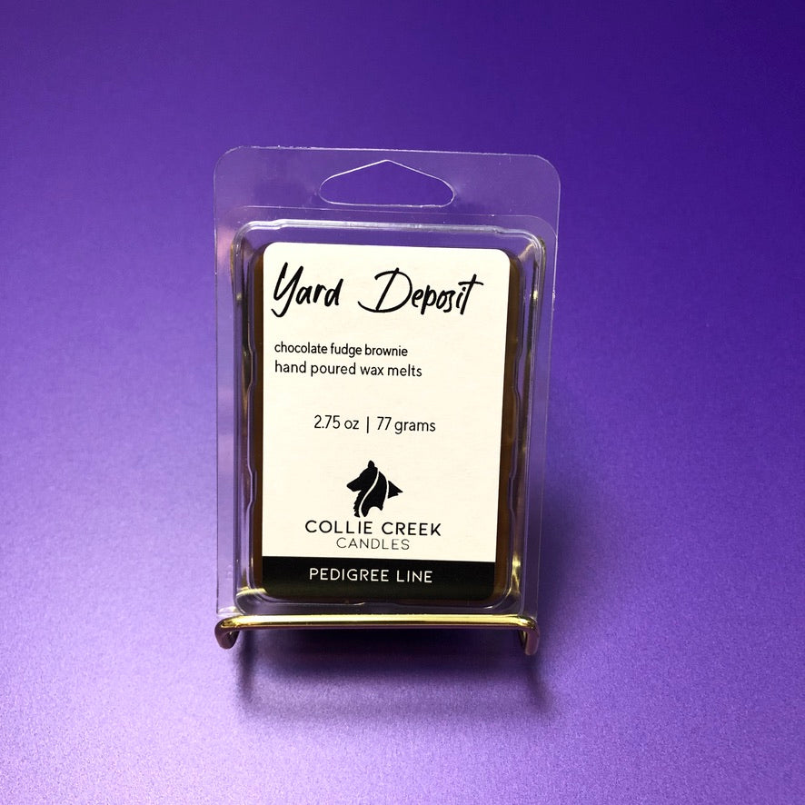 Dyed brown like a chocolate fudge brownie or Yard Deposit 6-cavity wax melt on purple background.