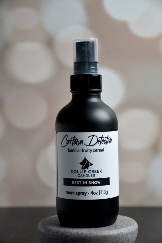 4 oz matte black bottle with white label with black lettering. This room spray comes in many scent profiles. This scent profile called Cartoon Detective and is a familiar, fruity cereal - you can even smell the yummy dust from the bottom of the cereal box, from Collie Creek Candles.