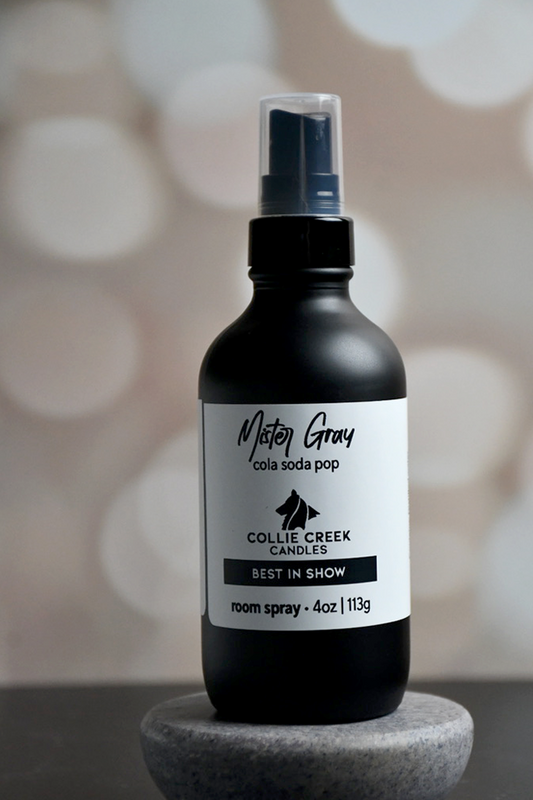 4 oz matte black bottle with white label with black lettering. This room spray comes in many scent profiles. This scent profile called Mister Gray, is a cola, soda pop, from Collie Creek Candles.