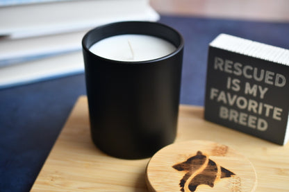 Matte black, single wicked candle in a living room setting.