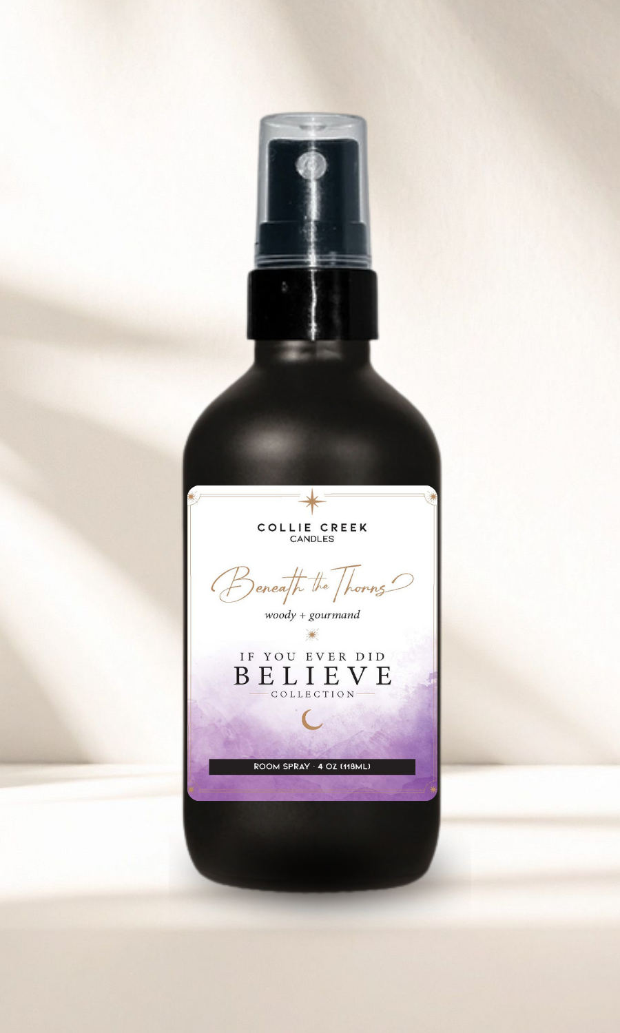 Beneath the Thorns Room Spray 4 ounce bottle on a cream background.