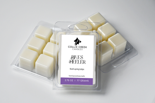 Grouping of naturally colored wax melts in clam shells. The label reads Blues Heeler, fresh spring tulips, below the Collie Creek Candles logo.
