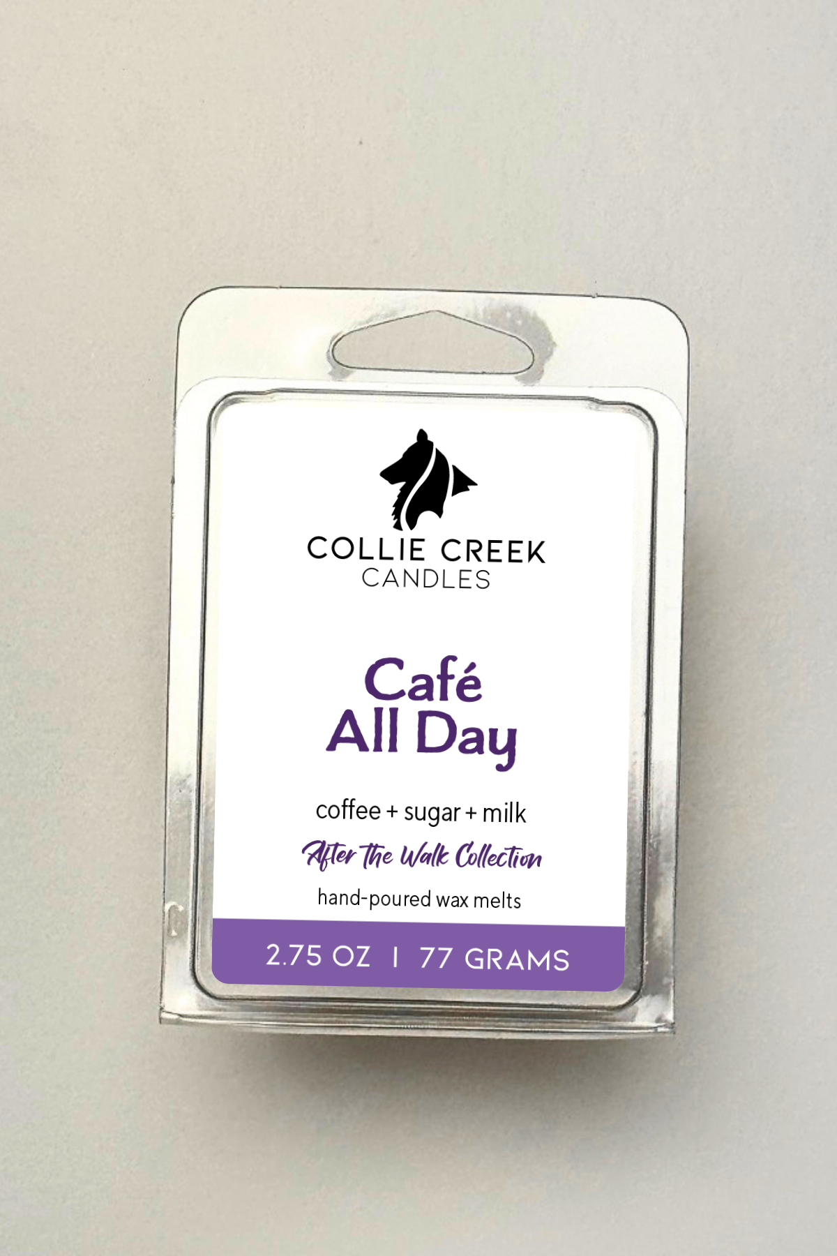Single wax melt in a clear clam shell on a white background, Cafe All Day in purple on the label.