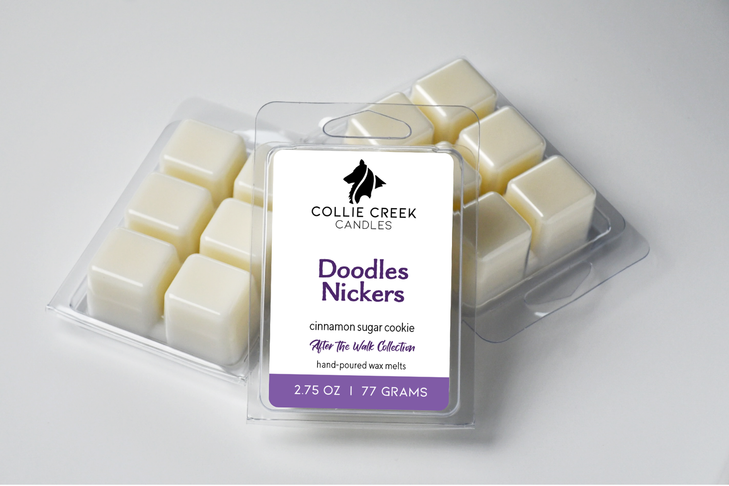 Grouping of wax melts in clear clam shells, Doodles Nickers in purple on the label.