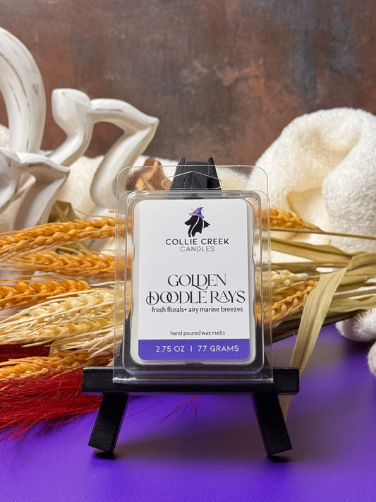 Collie Creek Candle Golden Doodle Rays wax melt packaging with decorative elements on a purple surface