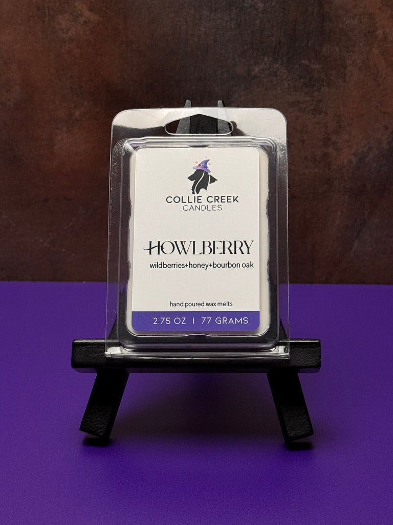 Collie Creek Candles Howlberry wax melt on a small easel against a dark background