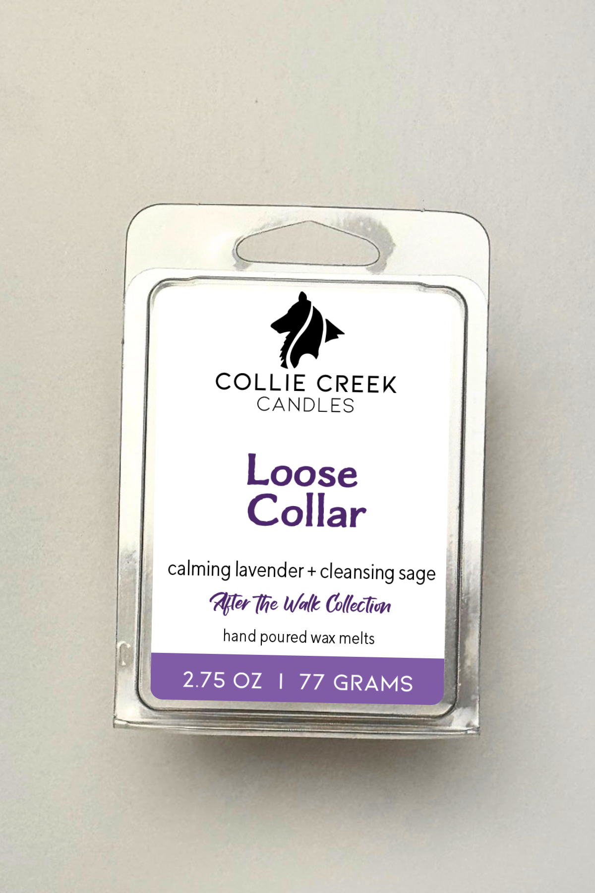 Single wax melt in a clear clam shell on a white background, Loose Collar in purple on the label.
