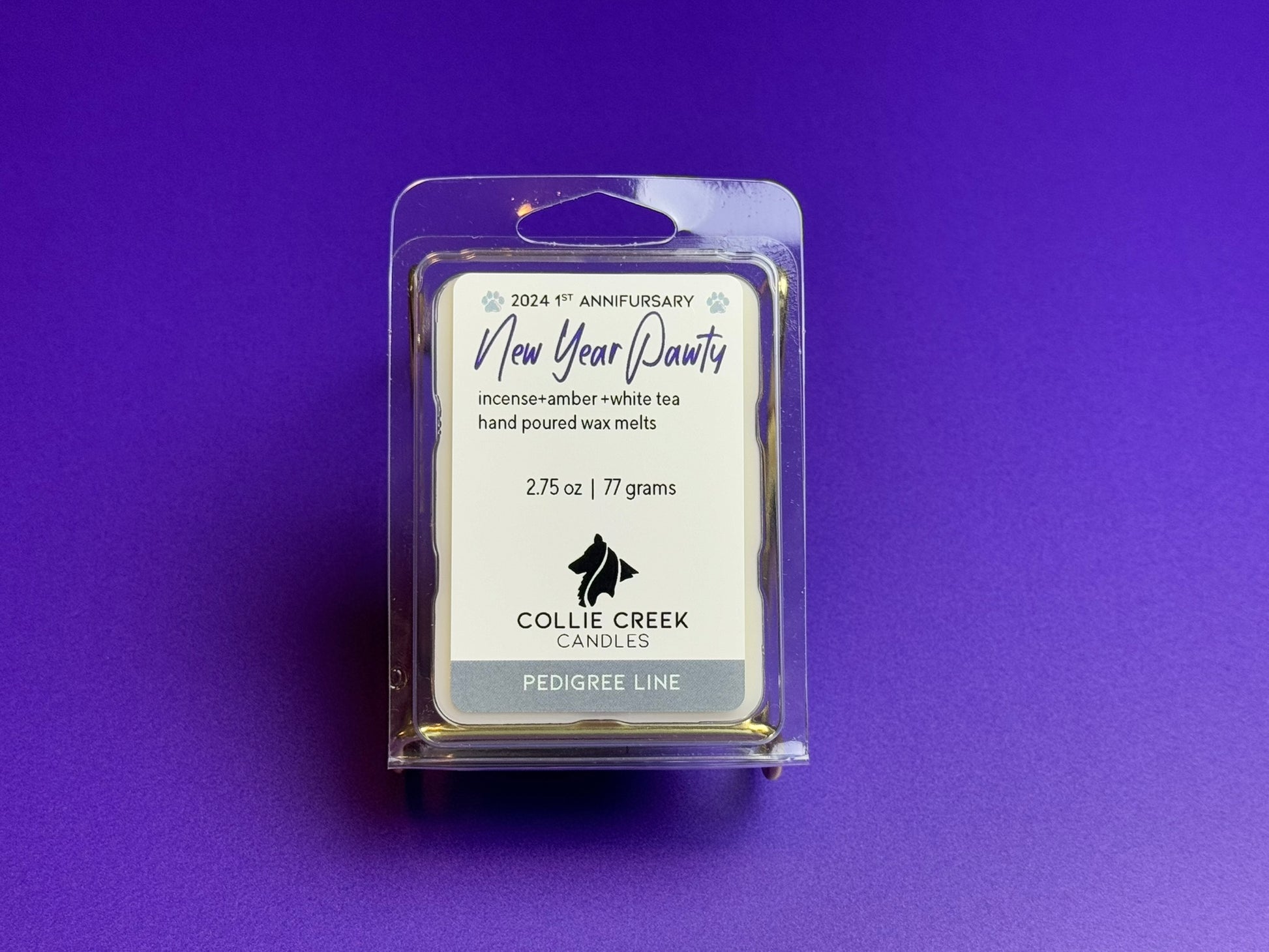 Wax melt called New Year Pawty from Collie Creek Candles on a field of purple