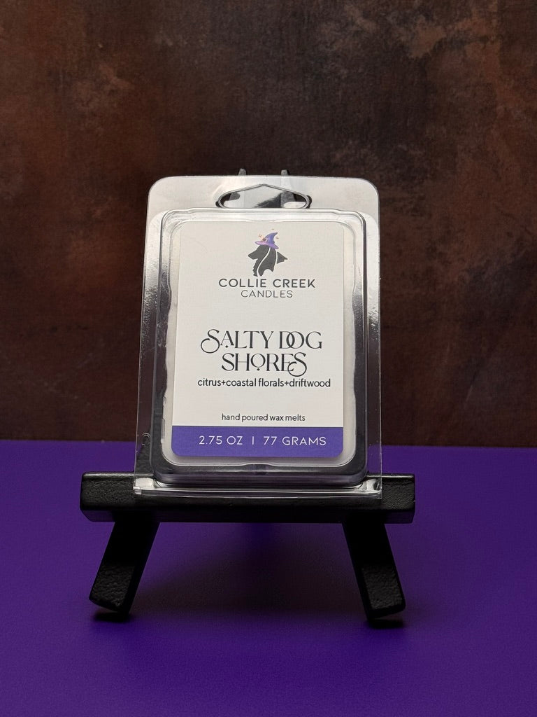 Collie Creek Salty Dog Shores wax melt packaging on a dark stand against a purple background